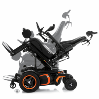 The F5 Corpus VS standing wheelchair is shown in a tilted position. It has orange accents and black rehab seating, including a headrest. thumbnail